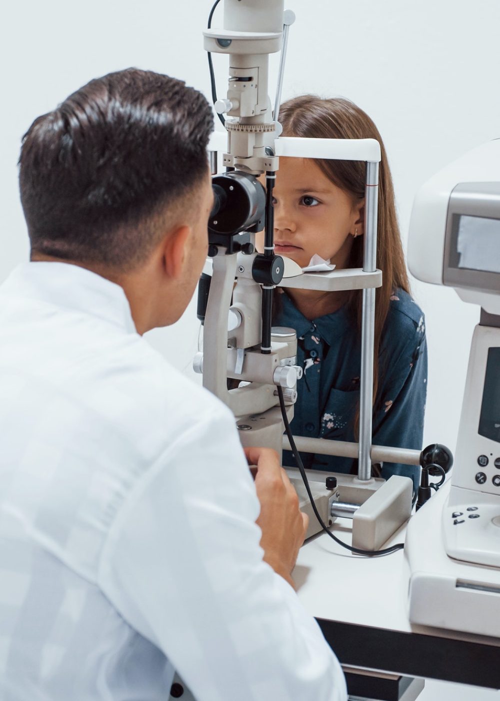 young-ophthalmologist-is-with-little-female-visitor-in-the-clinic.jpg